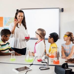 A teacher is instructing a class of children in a classroom.